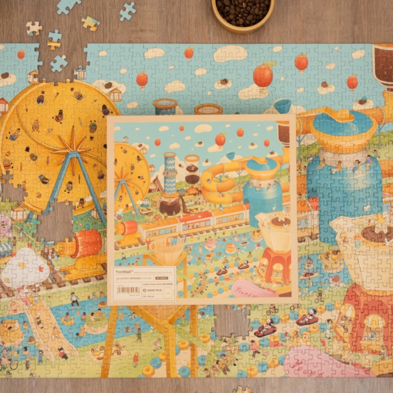 Partially completed Coffee Theme Park 1000 piece puzzle with product box placed on top.