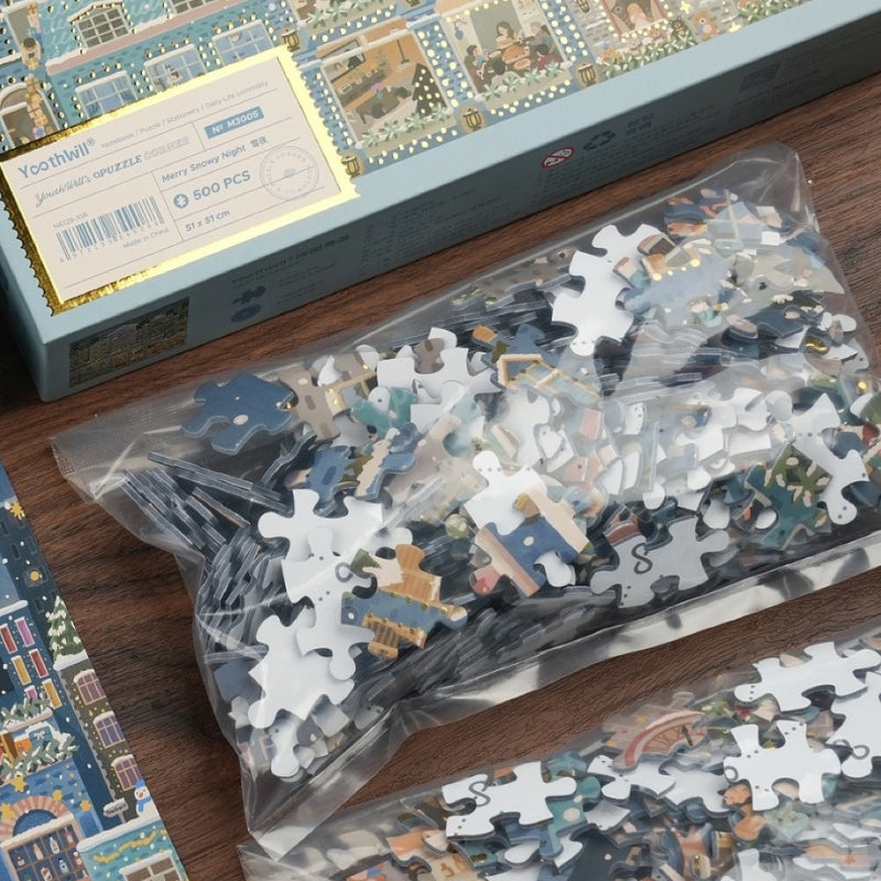 Puzzle box and sealed plastic bag filled with puzzle pieces.