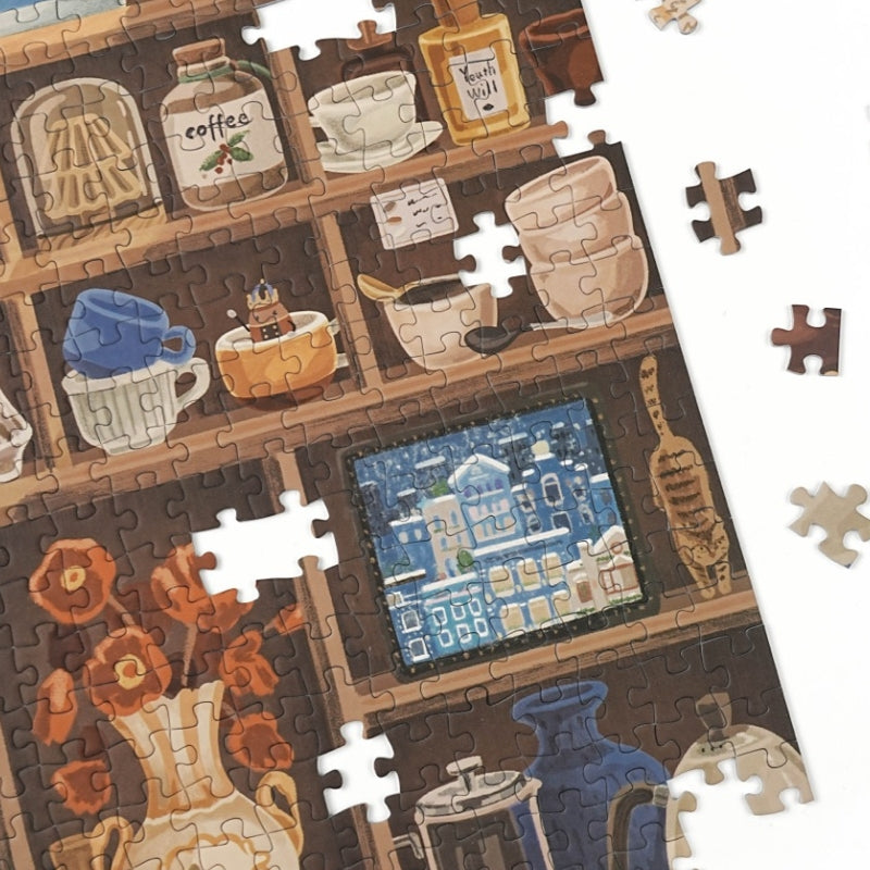 Puzzle detail showing cups, jars, and small framed artwork.
