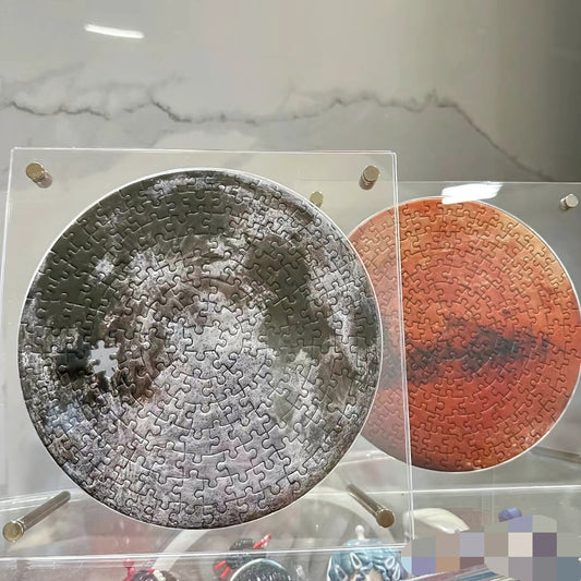 Moon and Mars round puzzles in acrylic frames, one puzzle shown incomplete.