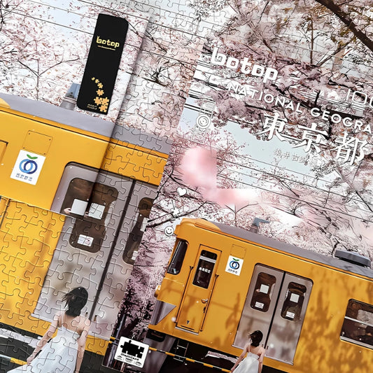 Partially assembled sakura train puzzle with box placed on the finished image