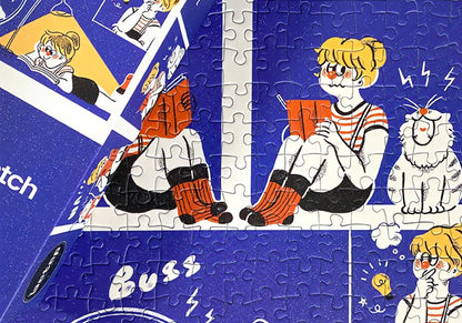 Close-up of assembled puzzle showing girl reading a book beside a cat and hamster in a wheel.