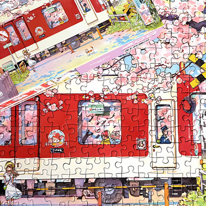 Assembled Sakura Train puzzle laid flat with box lid beside, featuring cherry blossoms and detailed train illustration