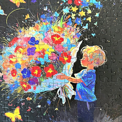 Close-up of Send Flowers puzzle pieces showing vivid colours, detailed flowers, and a boy holding a bouquet