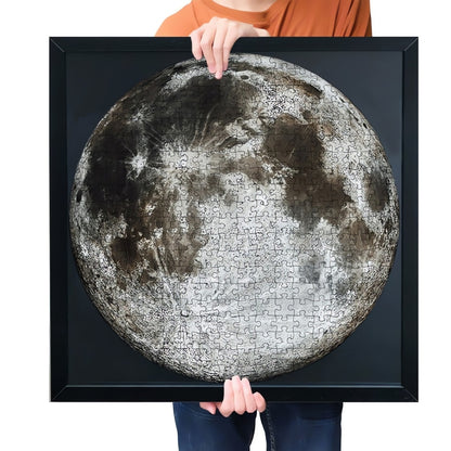 Framed moon puzzle held up, showing realistic lunar surface in high detail.