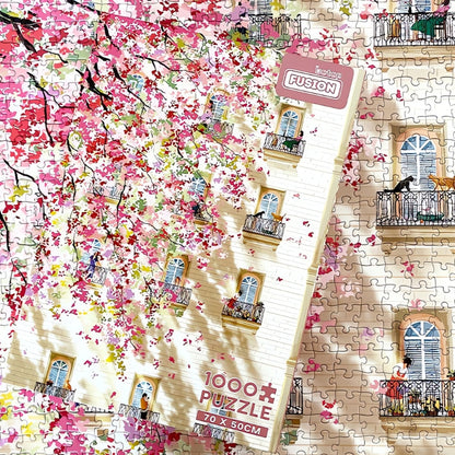 Afternoon puzzle box placed over assembled puzzle of floral and building details