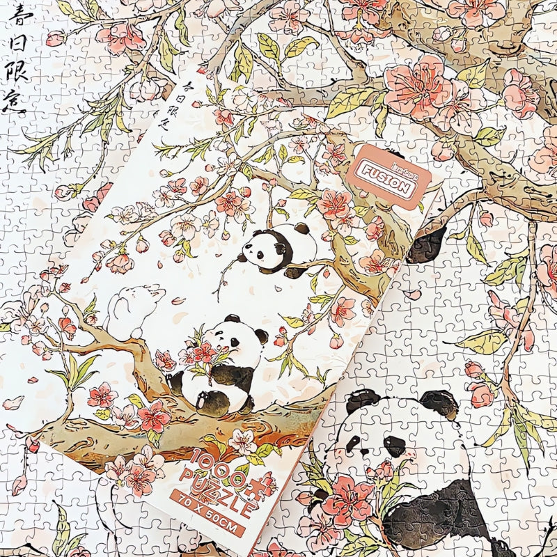 Spring Day puzzle box placed over assembled cherry blossom puzzle with pandas