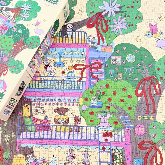 Partially completed Forest Tree House puzzle with the box on top, showing colourful rooms and trees decorated with red bows