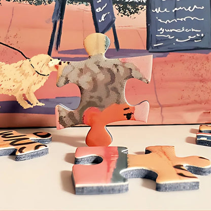 Loose puzzle pieces on table with artwork detail – seaside town puzzle.