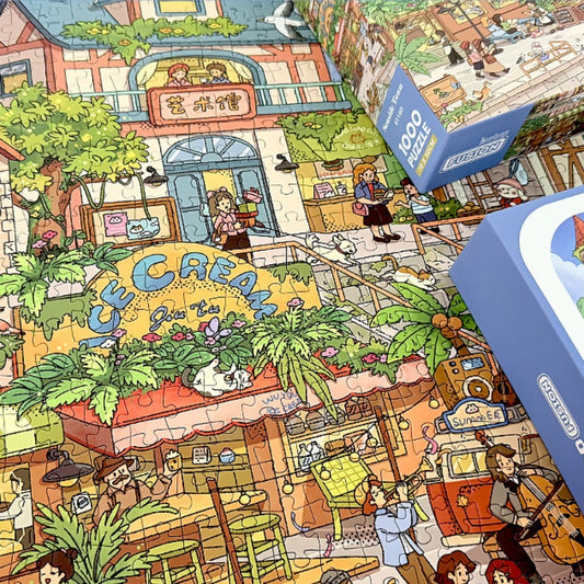 Completed Seaside Town puzzle with box showing detailed cartoon-style seaside street full of shops and people
