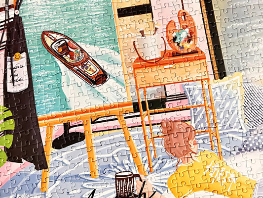 Close-up of puzzle showing boat painting and ocean view – coastal living puzzle.