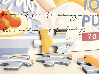 Puzzle pieces beside box with fruit and fabric detail – coastal living puzzle.