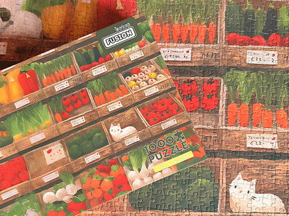 Vegetable Cat puzzle laid out with the box resting on top, showing artwork match and completed detail.