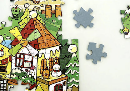 Close-up of edge pieces with windmill house, green trees and scattered snow ready to be placed