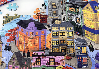 Zoomed-in section of Wizarding World puzzle with colourful fantasy-style shops and characters in black robes