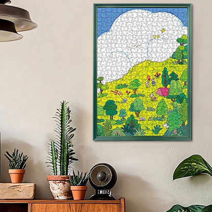 Framed completed Hillside puzzle hanging on a wall in a cosy room with houseplants.
