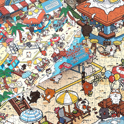Close-up of Cat Beach puzzle with box on top, showing detailed illustrations of cats playing on the sand.