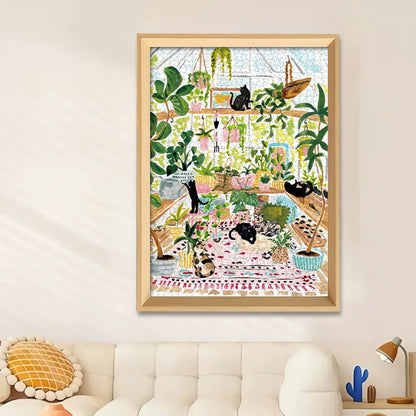 Framed Greenhouse Cats puzzle displayed above a white couch in a bright, modern living space.