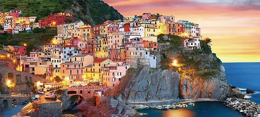 Scenic view of Cinque Terre’s vibrant cliffside houses at golden hour by the sea.