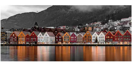 Lakeside town puzzle with colorful houses reflecting on calm water and mountain backdrop.