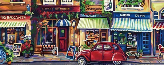 Paris street puzzle with cafés, shops, and red car in a painted village scene.