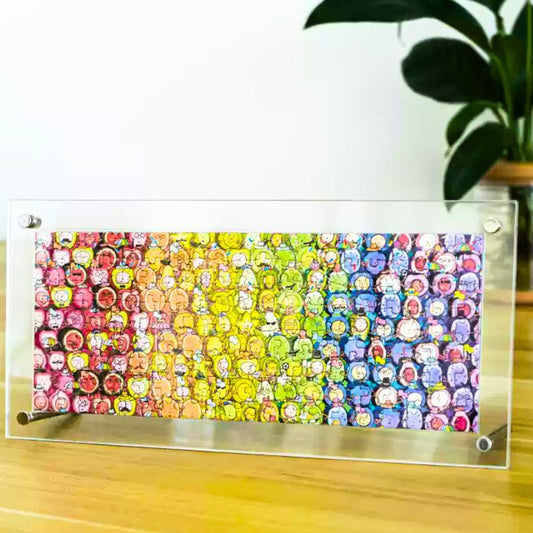 Completed Rainbow Fruits puzzle displayed in clear acrylic frame on table.
