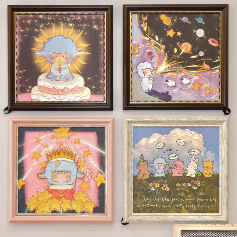 Wall display featuring four framed PERMA jigsaw puzzles, including the ‘Let the Candles Burn’ puzzle alongside three other whimsical designs.