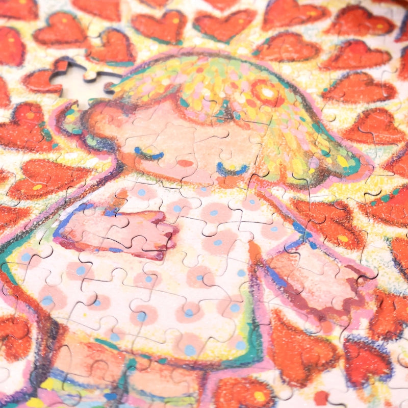 Close-up of the partially assembled “Love Out Loud” puzzle focusing on the character’s heart detail.