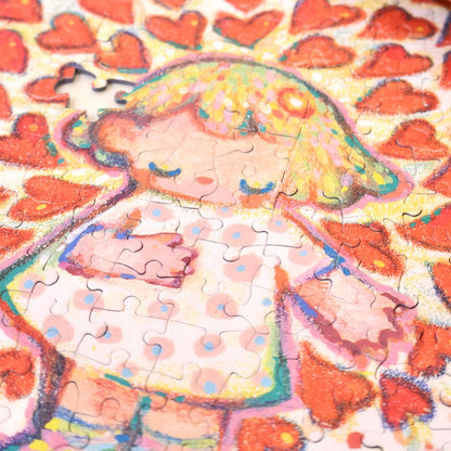 Close-up of the partially assembled “Love Out Loud” puzzle focusing on the character’s heart detail.
