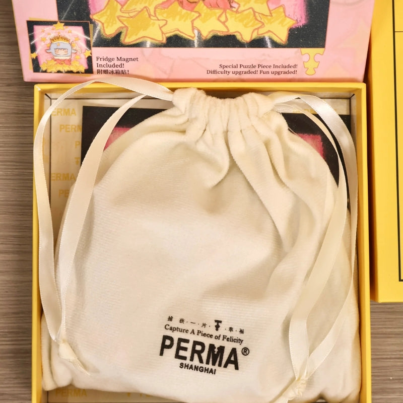 White PERMA drawstring pouch neatly placed inside the puzzle box for piece storage.
