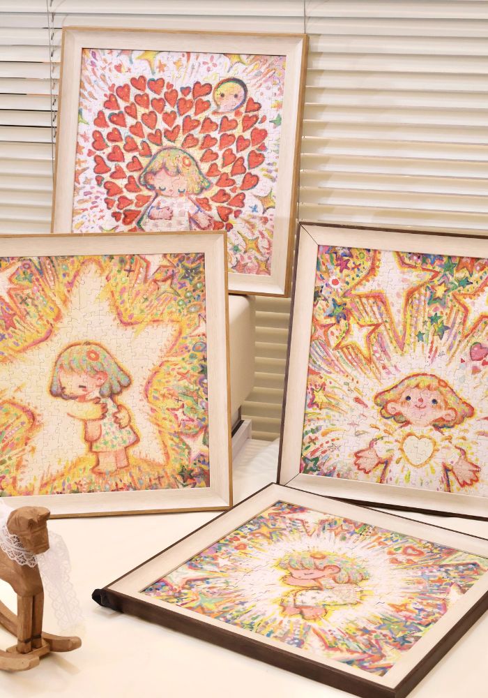A collection of framed puzzles from the PERMA Tiny Me series, including The Stars Know It All, arranged on a tabletop.
