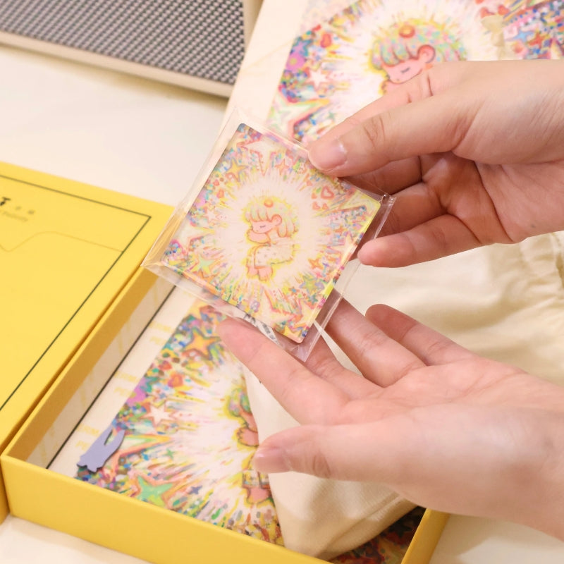 Person holding the bonus fridge magnet featuring the puzzle’s central starry artwork.