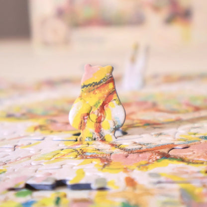 Close-up side view of a special-shaped puzzle piece standing upright within the completed puzzle.