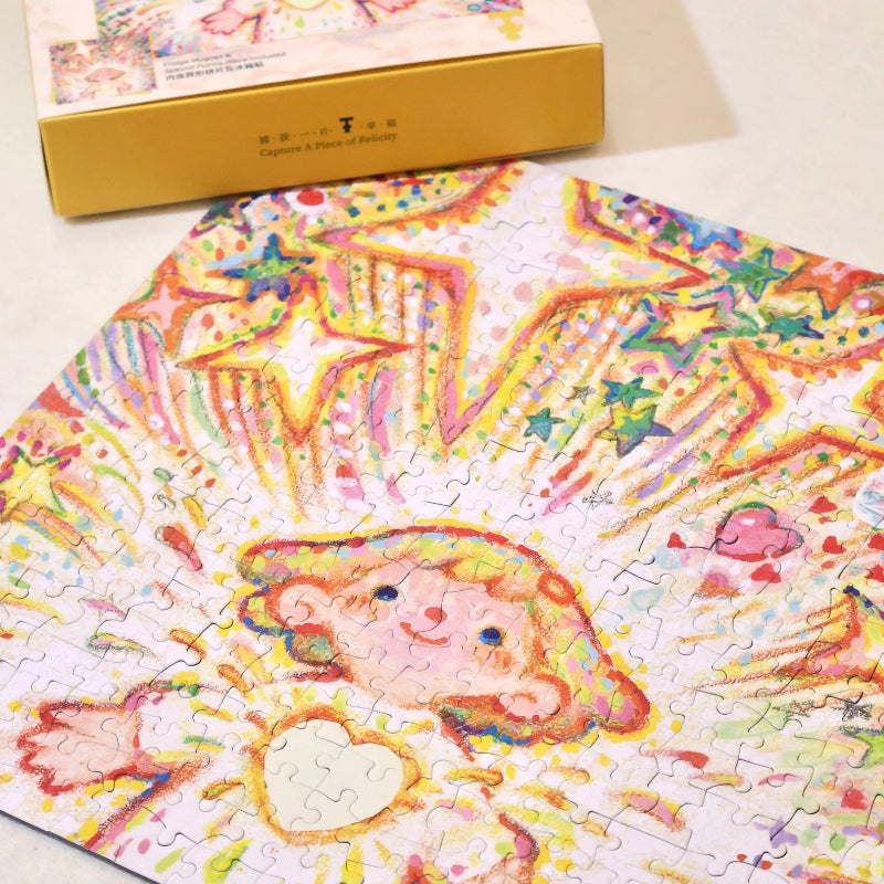Close-up of nearly completed “Tiny Me, Mighty Power” puzzle with box in the background.