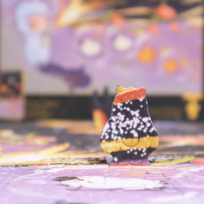 Close-up of a special-shaped puzzle piece standing upright on the assembled jigsaw, designed with a galaxy-inspired pattern.