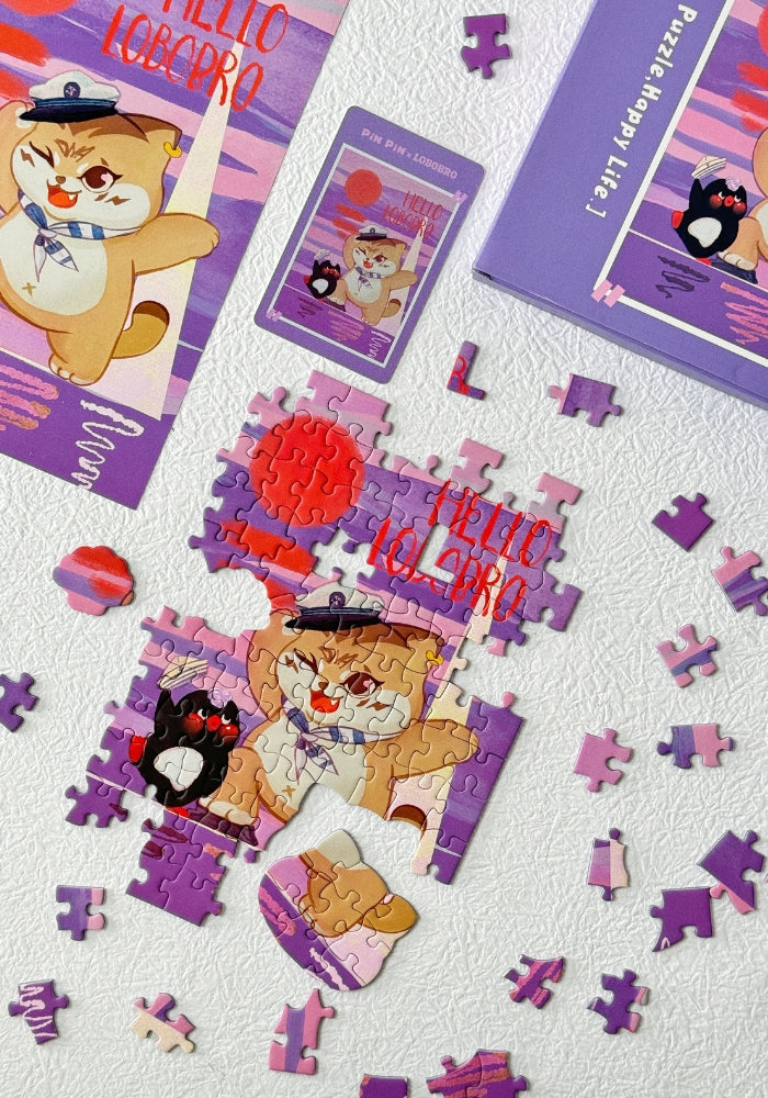 Partially assembled Hello Lobobro Mini Puzzle with scattered purple pieces.