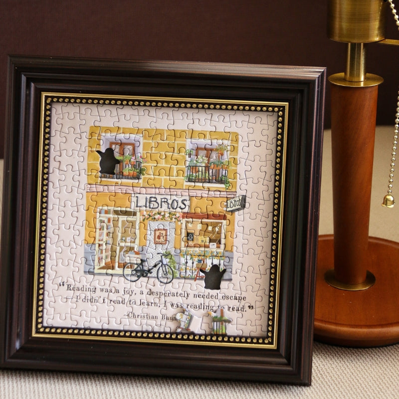 Framed completed Libros mini puzzle displayed as decorative wall art.