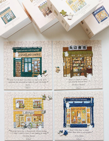 Flat lay of framed bookstore puzzles including Libros, Shakespeare & Company, Lost City Books, and others.