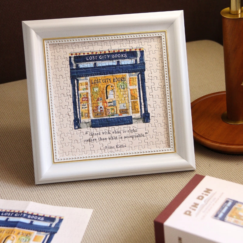 Framed completed Lost City Books puzzle displayed on a table.