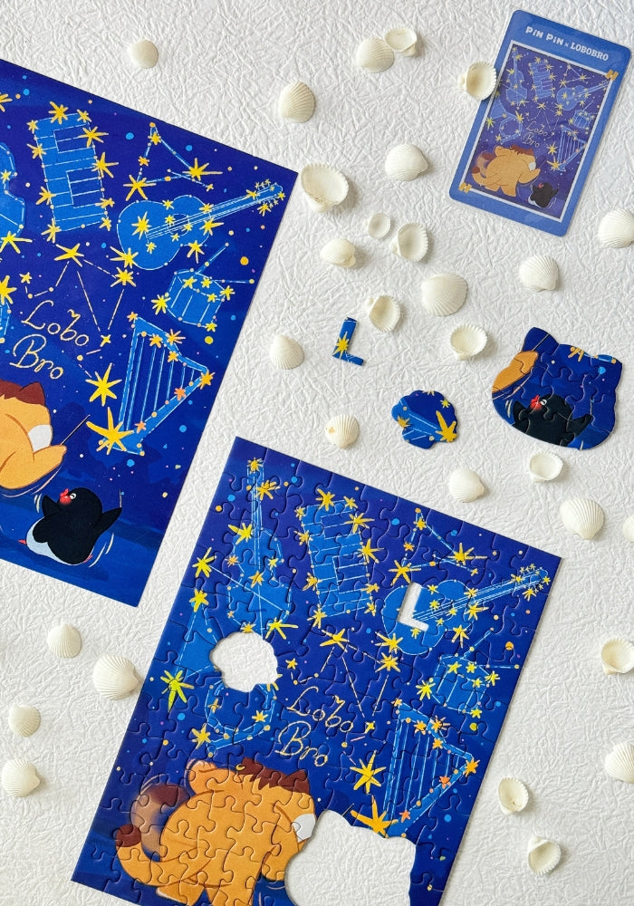 Puzzle pieces in progress with partial image of Lobobro and penguin under golden star constellations.