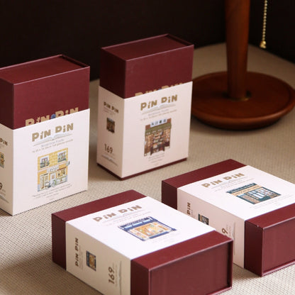 Set of Pin Pin Mini Bookstore puzzles in maroon and cream boxes, collectible bookish puzzle series.