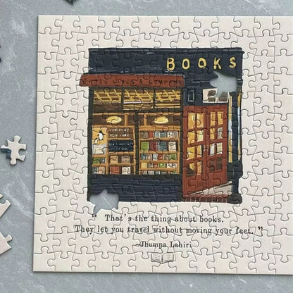 Partially assembled Three Lives & Company bookstore puzzle with Jhumpa Lahiri quote.