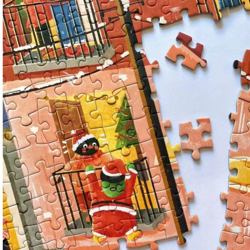 Close-up of Pinpin Blessed Night 1000 piece jigsaw puzzle showing characters in Santa outfits and festive decorations.