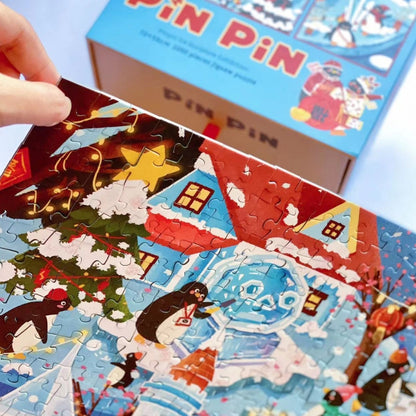Close-up of Pinpin Ice Sculpture Exhibition puzzle showing penguins and ice sculptures with the puzzle box in the background.