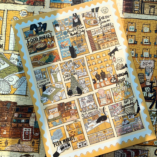 Puzzle pieces with a postcard-sized image of the Black Cat’s Diary artwork placed on the completed puzzle.