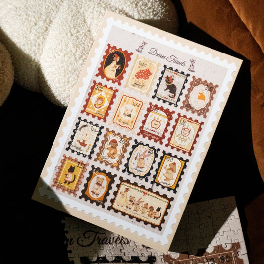 Dream Travels puzzle box resting on a fluffy blanket, showing vintage-style stamp illustrations
