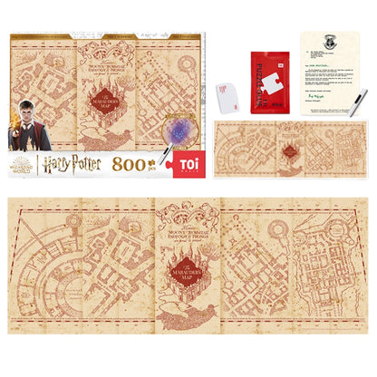 Flat lay of full Marauder’s Map puzzle set with box, completed puzzle, UV torch, glue, scraper, and Hogwarts letter.