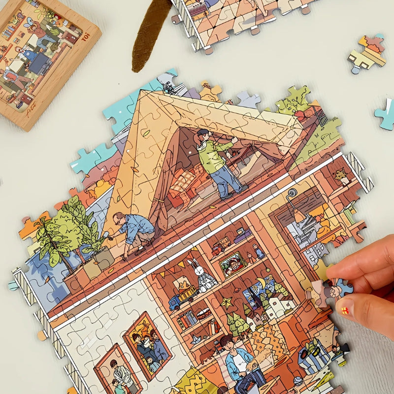A puzzle piece being placed into the nearly finished “Home Sweet Chaos” puzzle.