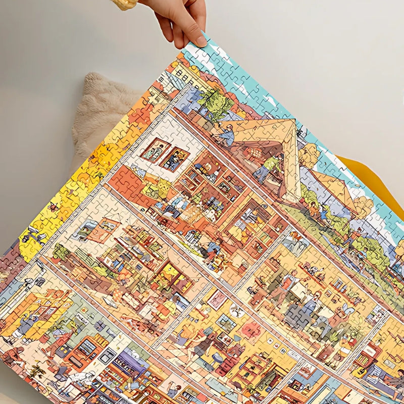 Holding up the finished “Home Sweet Chaos” puzzle to show its full design.