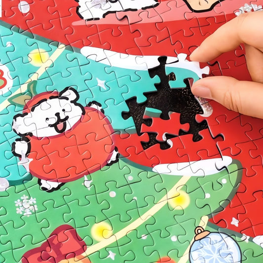 Close-up of hand placing piece in TOI Maltese Puppy Christmas puzzle showing red and green holiday design